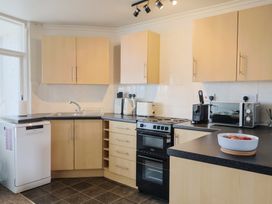 A kitchen with cabinets and appliances at 4 Kingfisher Court West Bay