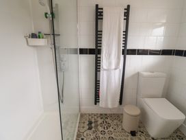 A bathroom with a shower and toilet at 4 Kingfisher Court West Bay