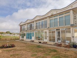An exterior view of a building with balconies and outdoor furniture at 4 Kingfisher Court in West Bay