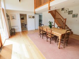 A dining room with a wooden table and chairs at Wayside in Moreton-in-Marsh