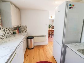 A kitchen with cabinets, countertop, and refrigerator at Wayside in Moreton-in-Marsh