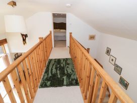 A landing with a wooden banister and a rug at Wayside in Moreton-in-Marsh