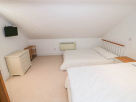 A bedroom with two beds and a dresser at Wayside Moreton-in-Marsh