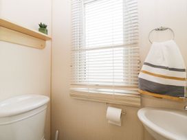 A bathroom with a toilet and sink at The Hideaway in Portesham