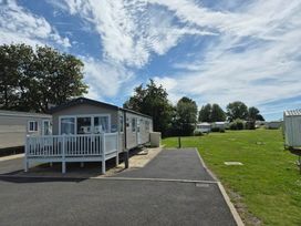 A mobile home with a deck and driveway at Marton mere Westminster Blackpool