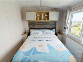 A bedroom with a bed and decorative items at Marton mere Westminster Blackpool
