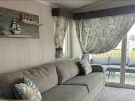 A living room with a sofa and decorative items at Marton mere Westminster Blackpool