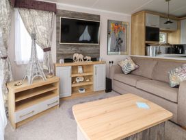 A living room with a sofa and television at Marton Mere Westminster in Blackpool