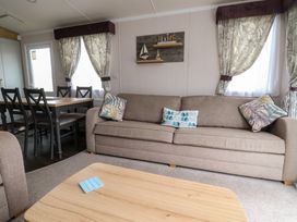 A living room with a sofa and dining table at Marton Mere Westminster in Blackpool