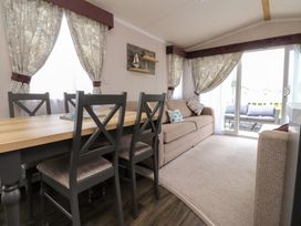 A living room with a sofa and dining table at Marton Mere Westminster in Blackpool