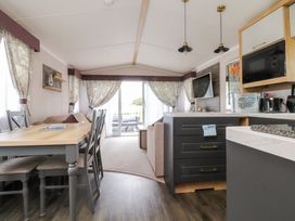 A living room with a dining table and sofa at Marton Mere Westminster in Blackpool