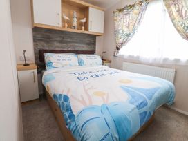 A bedroom with a bed and shelf at Marton Mere Westminster Blackpool