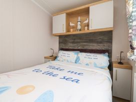 A bedroom with a bed and decorative items at Marton Mere Westminster in Blackpool
