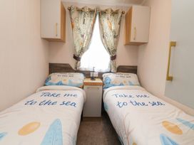 A bedroom with two beds and a window at Marton Mere Westminster in Blackpool