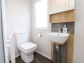 A bathroom with a toilet and sink at Marton Mere Westminster in Blackpool