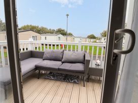 A balcony with a sofa and table at Marton Mere Westminster Blackpool