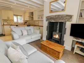 A living room with a sofa and fireplace at Awelfryn in Betws-y-Coed