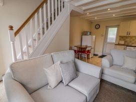 A living room with a sofa and dining table at Awelfryn in Betws-y-Coed