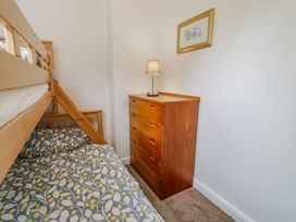 A bedroom with a bunk bed and a dresser at Awelfryn in Betws-y-Coed