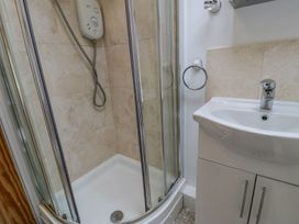 A bathroom with a shower and sink at Awelfryn in Betws-y-Coed