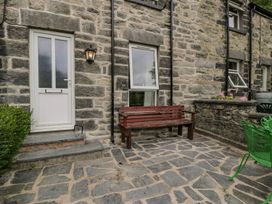 An outdoor area with a bench and door at Awelfryn in Betws-y-Coed