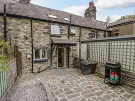 An outdoor area with a back door and grill at Awelfryn in Betws-y-Coed
