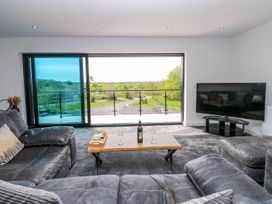 A living room with a sofa and television at Sycamore Cottage Frizington