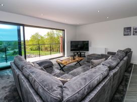 A living room with a sofa and coffee table at Sycamore Cottage in Frizington