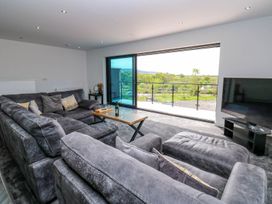 A living room with a sofa and television at Sycamore Cottage in Frizington