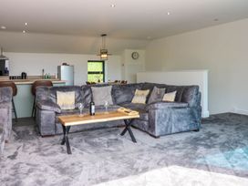 A living room with a sofa and coffee table at Sycamore Cottage in Frizington