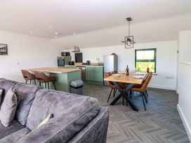 A kitchen and dining area with a sofa and dining table at Sycamore Cottage in Frizington