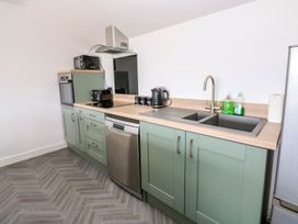 A kitchen with cabinets and appliances at Sycamore Cottage Frizington
