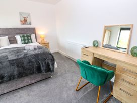 A bedroom with a bed and desk in Sycamore Cottage in Frizington