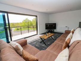 A living room with a sofa and coffee table at Silver Birch Cottage in Frizington