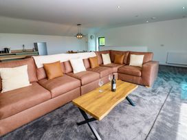 A living room with a sofa and coffee table at Silver Birch Cottage in Frizington