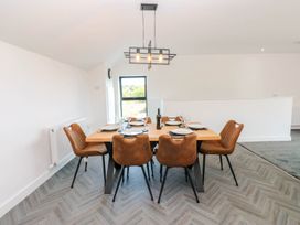 A dining room with a table and chairs at Silver Birch Cottage Frizington