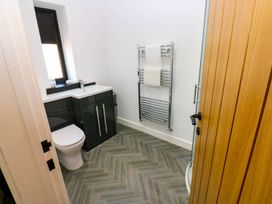 A bathroom with a toilet and sink at Silver Birch Cottage in Frizington