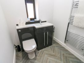 A bathroom with a toilet and sink at Silver Birch Cottage in Frizington