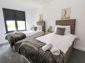 A bedroom with two single beds at Silver Birch Cottage in Frizington