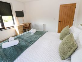 A bedroom with a bed and desk at Silver Birch Cottage in Frizington