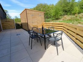 An outdoor space with a table and chairs at Silver Birch Cottage in Frizington
