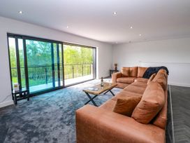 A living room with a sofa and sliding doors at Oak Tree Cottage in Frizington