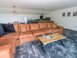 A living room with a sofa and coffee table at Oak Tree Cottage in Frizington