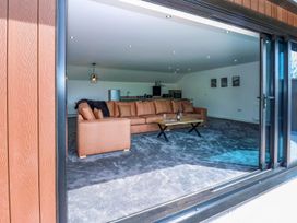 A living room with a sofa and table at Oak Tree Cottage in Frizington