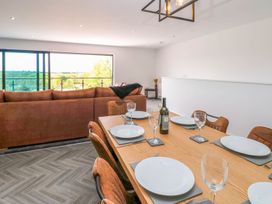A dining room with a table set for dinner at Oak Tree Cottage in Frizington