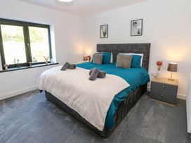 A bedroom with a double bed and two lamps at Oak Tree Cottage in Frizington