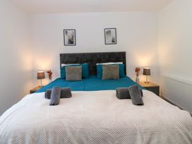 A bedroom with a bed and bedside lamps at Oak Tree Cottage in Frizington