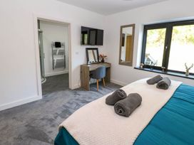A bedroom with bed and desk at Oak Tree Cottage in Frizington