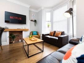 A living room with a television and sofa at 38 Ashville Avenue in Scarborough