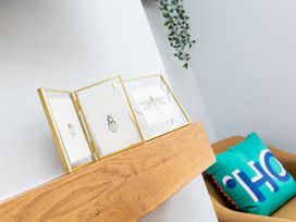 A shelf with framed artwork and a cushion at 38 Ashville Avenue, Scarborough